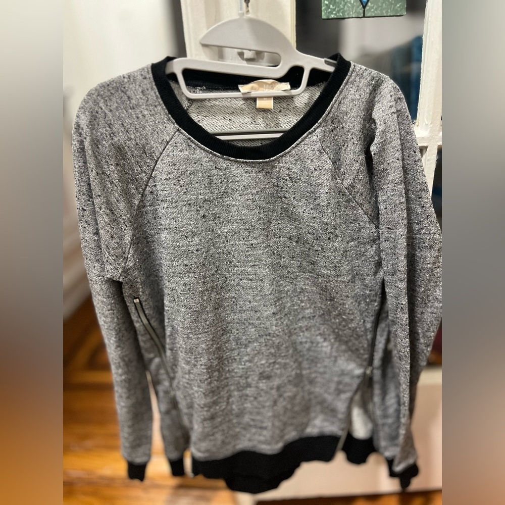 Black and gray woman’s Michael Kors sweatshirt